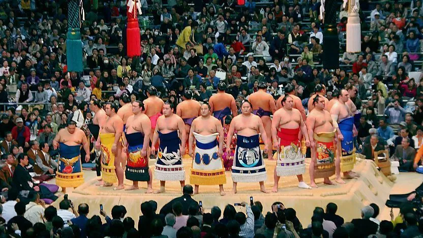 Sumo wrestlers in ceremonial kesho-mawashi aprons during the ring-entering ceremony in Japan
